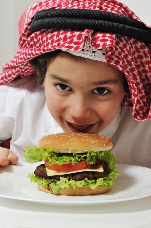 Arabic kid with burgerの写真素材