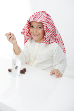 A little muslim boy wearing islamic attire ready for braking Ramadan fastの写真素材