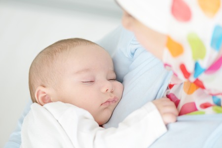 Beautiful baby of two months old in his muslim mothers hands.の写真素材