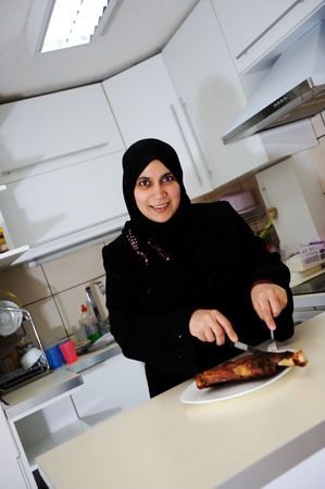 Beautiful muslim woman in the kitchenの写真素材
