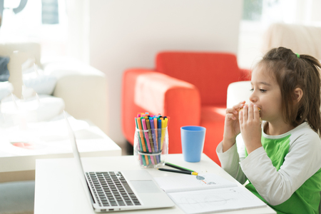 Little boy at home using laptopの写真素材
