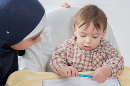 Mother Teaching Her baby Toddler to Writeの写真素材