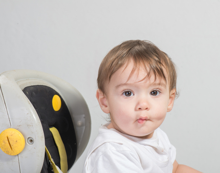 A Cute Toddler Baby Riding on a Car Toyの写真素材