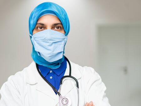 Muslim female doctor weaing protective maskの写真素材