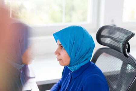 Muslim woman using technology for workの写真素材