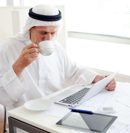 Lifestyle posing elderly senior businessman at officeの写真素材