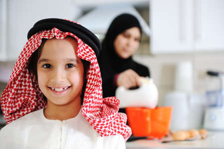 Muslim mother and little son in the kitchenの写真素材