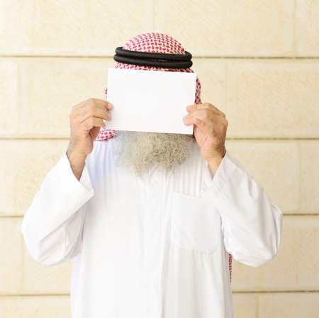 Man with long beard posing with empty copy space paper on his faceの写真素材