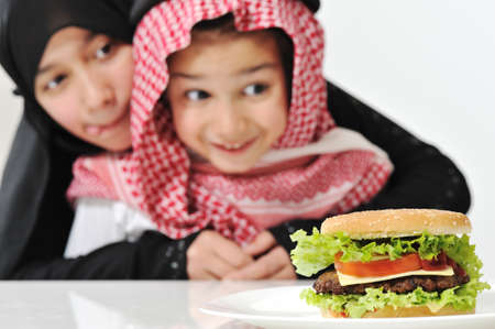 Arabic girl and boy with big Burgerの写真素材