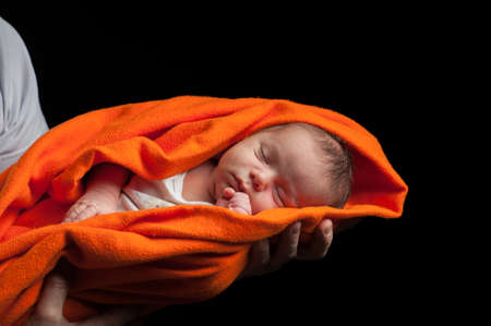 Newborn baby on black . High quality photoの写真素材