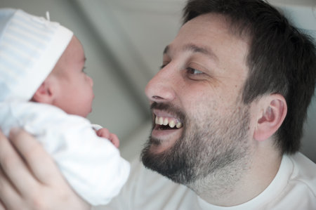 Man as a happy and loving father with newborn baby in the arms. High quality photo