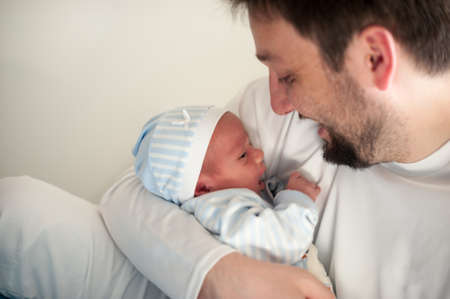 Man as a happy and loving father with newborn baby in the arms. High quality photoの写真素材