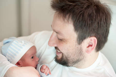 Man as a happy and loving father with newborn baby in the arms. High quality photo