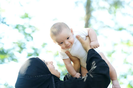 Mother and her baby enjoying in natureの写真素材