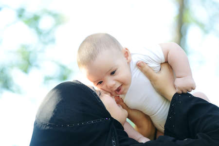 Mother and her baby enjoying in natureの写真素材