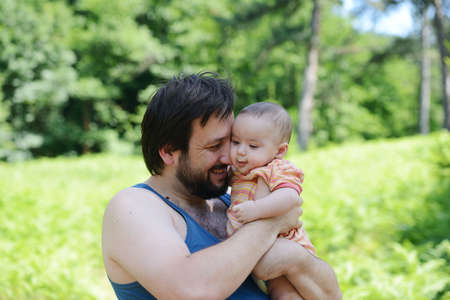 Father and his baby enjoying in natureの写真素材