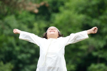 Little Arabic boy enjoying fresh air in natureの写真素材