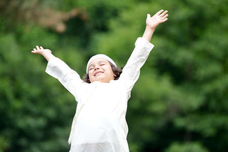Little Arabic boy enjoying fresh air in natureの写真素材