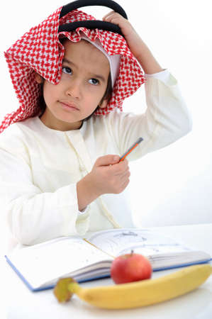 Arabic kid scratching his head gesture for thinkingの写真素材