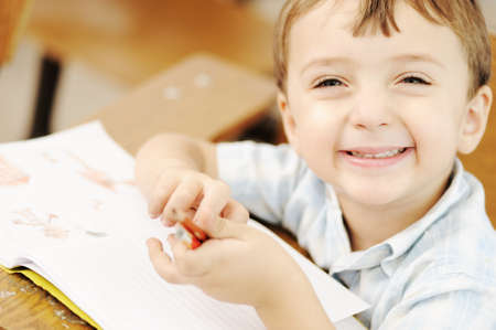 Happy children with their teacher in classroom, doingの写真素材