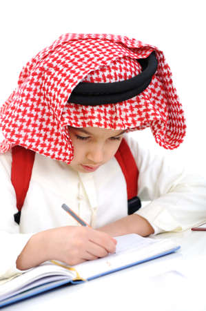 Arabic kid writing aloneの写真素材