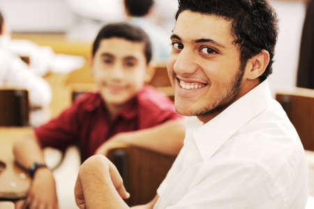 Happy children with their teacher in classroom, doing