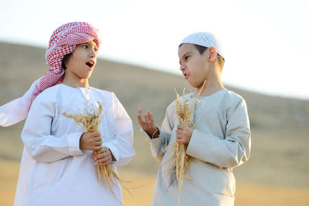 Kids on wheat fieldの写真素材