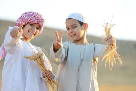 Kids on wheat fieldの写真素材