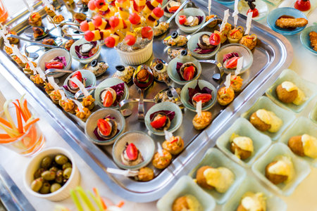 Beautifully decorated catering banquet table with different food snacks