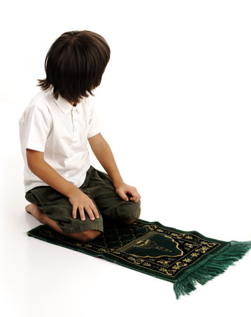 Muslim kid praying - series of related photos showing the entire prayerの写真素材