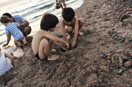 Group of children playing at shore sandの写真素材