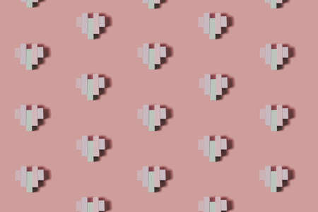 Creative pattern made of wooden block heart shapes. Love visual with pastel colors. Minimal flat lay...