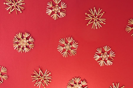 New Year goldy snowflake decoration on a bold red background. Flat lay Christmas pattern.