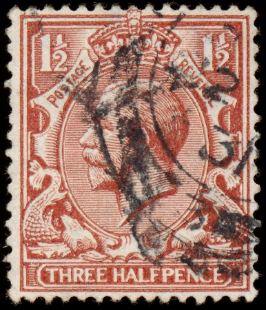 UNITED KINGDOM - CIRCA 1912 to 1924  An English Used Three Halfpence Brown Postage Stamp showing Portrait of King George V, circa 1912 to 1924 のeditorial素材