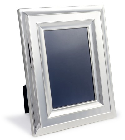 Blank silver photo frame at the desk with clipping path on white isolated backgroundの写真素材
