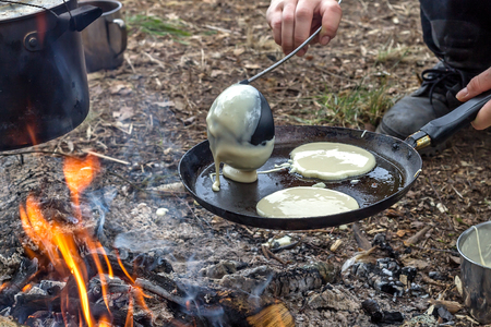 Cooking in the camp outdoor.  Boiling pot on the fire with eggsの写真素材