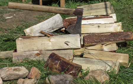 Cut logs firewood and old axe. Renewable resource of a energy. Environmental concept.の写真素材