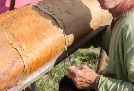 Master of birch bark case makes a canoe with their handsの写真素材