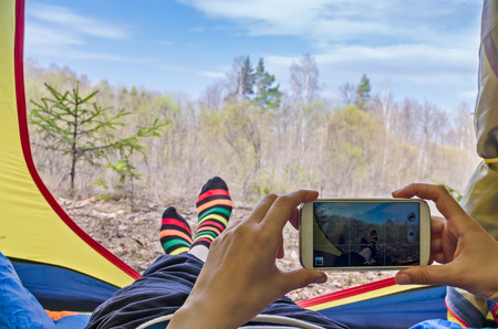 Feet woman relaxing from tent camping outdoor Travel Lifestyle concept nature on background. Summer vacationsの写真素材