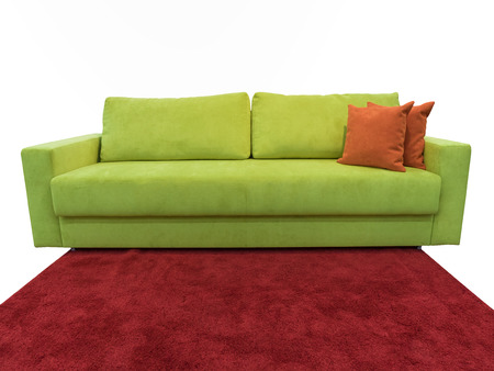 light green sofa with pillows on the red carpetの写真素材