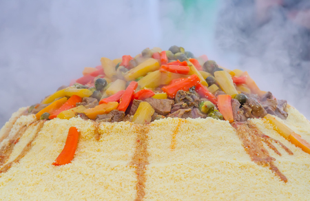 Preparation of a large couscous outdoors. Moroccan street festivalの写真素材