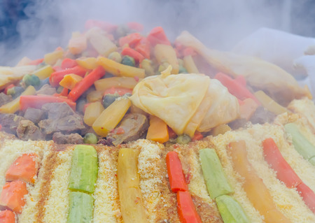 Preparation of a large couscous outdoors. Moroccan street festivalの写真素材