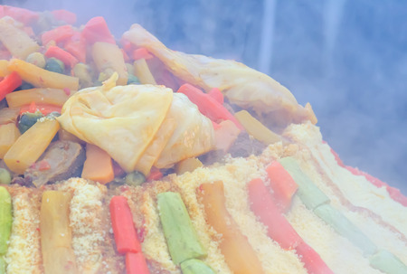 Preparation of a large couscous outdoors. Moroccan street festivalの写真素材