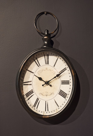 Vintage clock on brown wall backgroundの写真素材