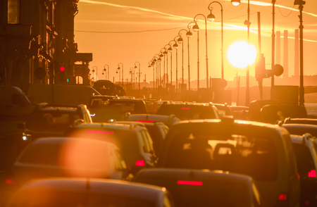 Cars are in a traffic jam during a beautiful golden sunset in a big sity.の写真素材