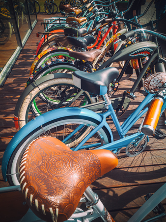 Many bikes in a row on the street. Bicycle parking. Colored bicycles on the street Backgroundの写真素材
