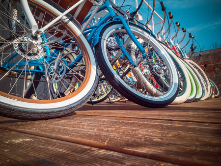 Many bikes in a row on the street. Bicycle parking. Colored bicycles on the street Backgroundの写真素材