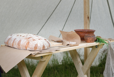Loaf of large bread on wooden table.の写真素材