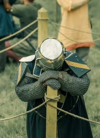 RITTER WEG, MOROZOVO, APRIL 2017: Festival of the European Middle Ages. Weary knight in helmet and chainmail resting after battle bending his head.