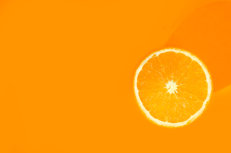 One orange on orange background. Art food conceptの写真素材